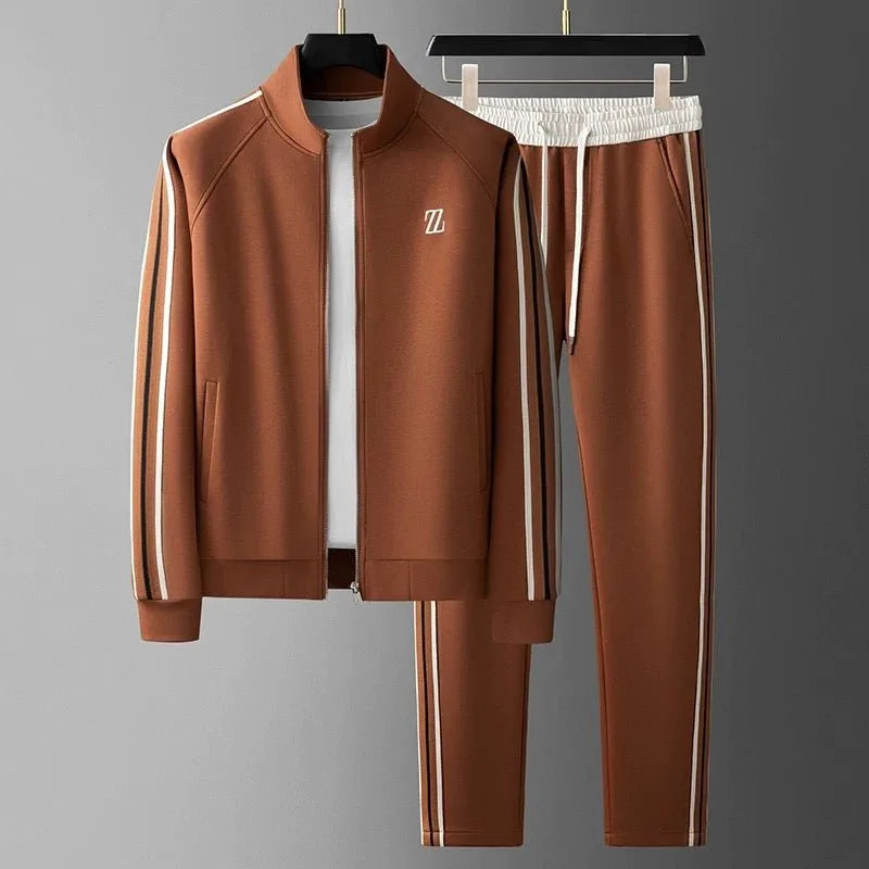 Chestnut brown tracksuit on hangers showing full-length zip jacket with striped sleeves and matching striped joggers