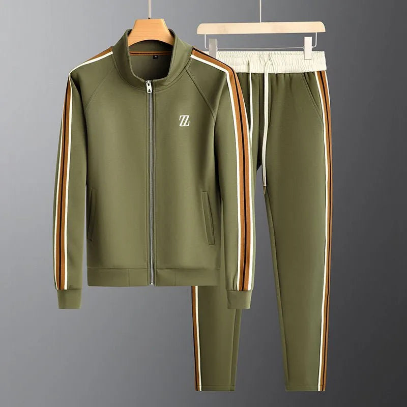 Olive green zip-up jacket and joggers on hangers, worn over a white t-shirt, with striped side panels
