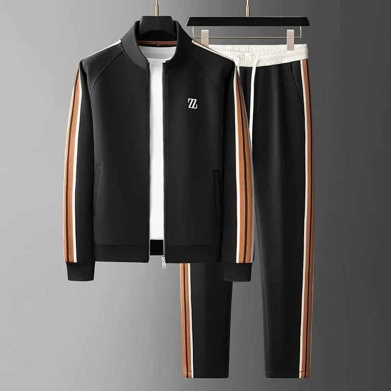 Black zip-up jacket and joggers on hangers with tan and white side stripes, worn over a white t-shirt