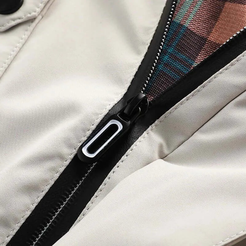 Close-up of the front zip pull and checked interior lining against the beige outer shell