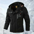 Front view of the beige jacket on a model, hood raised, showing zip pockets and branded patches