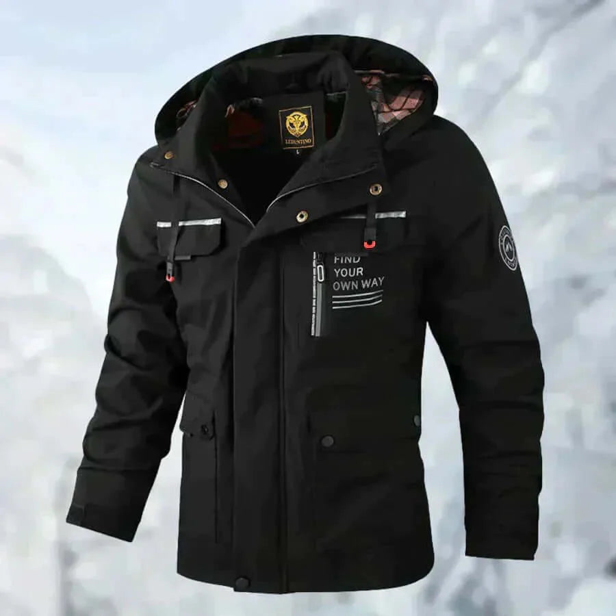 Front view of the beige jacket on a model, hood raised, showing zip pockets and branded patches