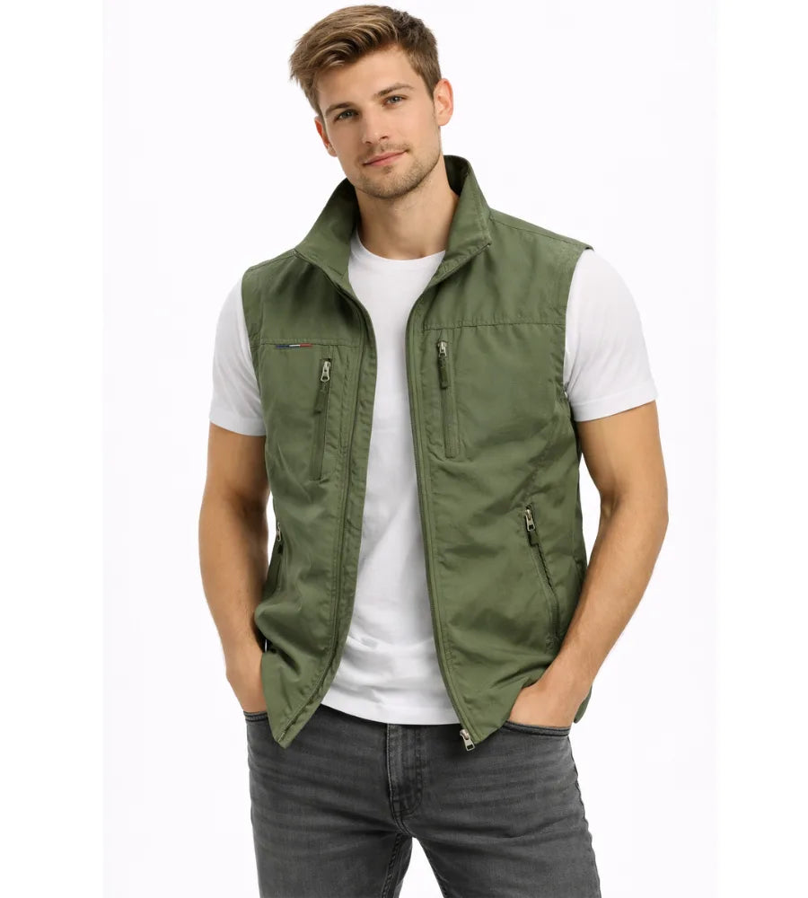 Olive green zip gilet with stand collar and four zip pockets, worn open over a white t-shirt