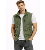 Olive green zip gilet with stand collar and four zip pockets, worn open over a white t-shirt