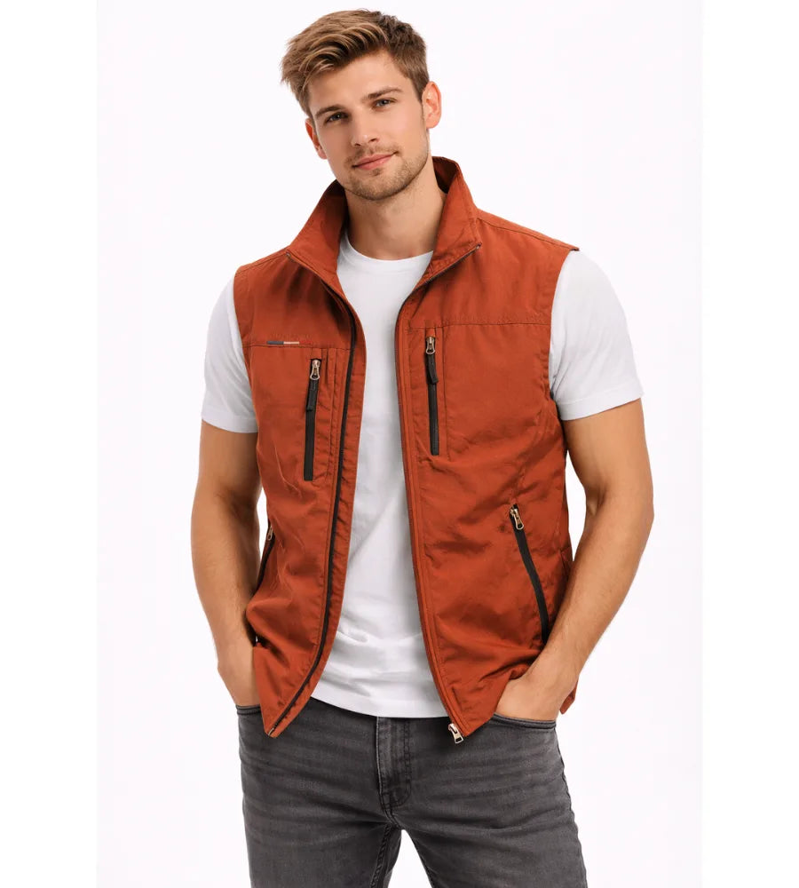 Rust orange zip gilet with contrast black zip trims and stand collar, worn open over a white t-shirt