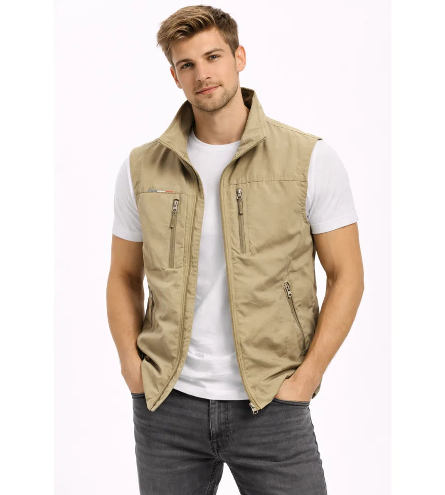 Khaki beige zip gilet with stand collar and zip pockets, worn open over a white t-shirt and jeans