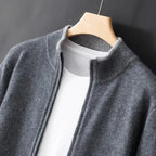 Close-up of grey zip cardigan on wooden hanger, ribbed stand collar and zip pull over white tee