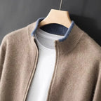 Camel knit cardigan with contrasting blue collar lining, zip detail shown close up on hanger