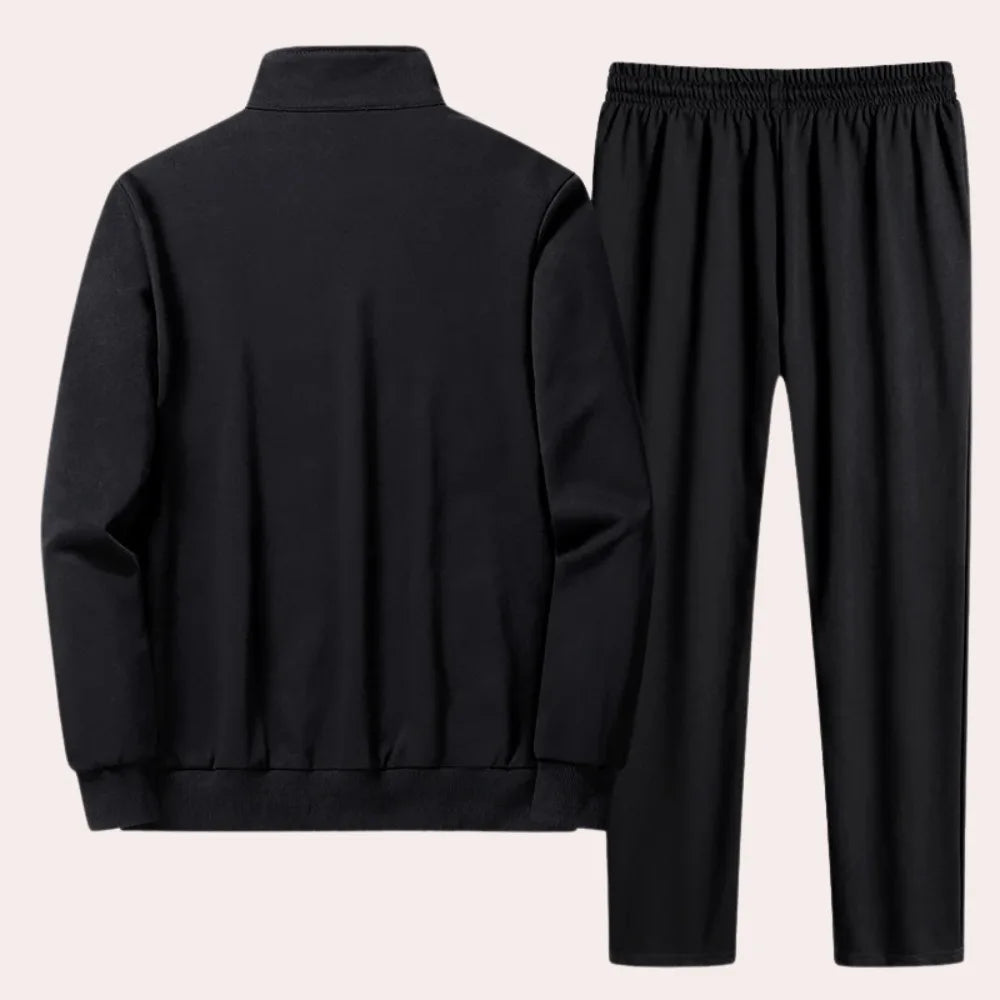 Rear view of black zip-up jacket and joggers, highlighting the plain back panel and elasticated waistband