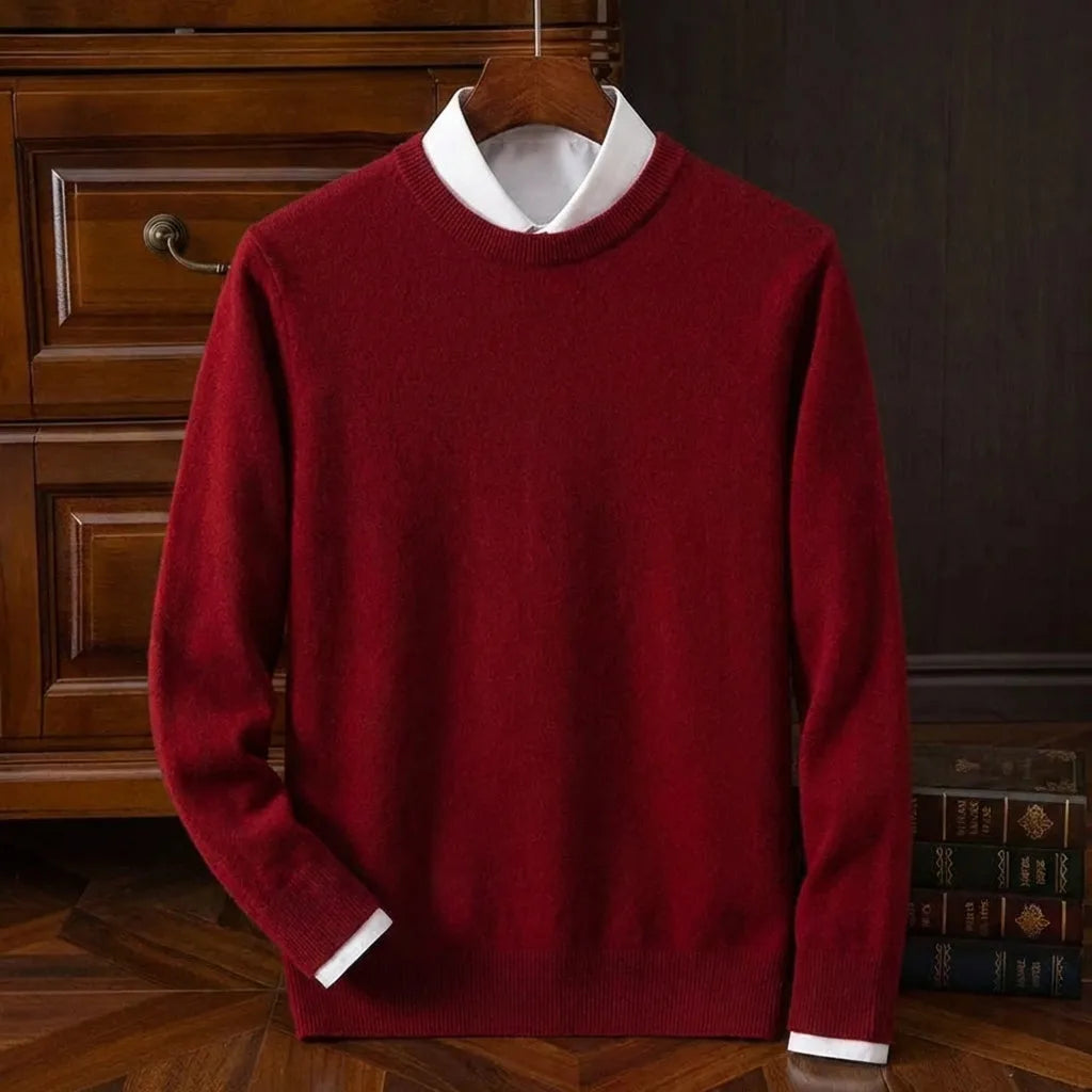 Front view of a deep red crew neck jumper layered over a white collared shirt, displayed on a wooden hanger