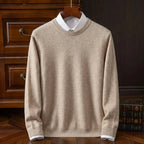 Light beige crew neck knit jumper with ribbed trim, hung over a white collared shirt near a stack of books