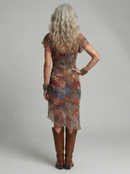 Back view showing the fitted ruched waist, flutter sleeves and softly draped asymmetrical hem of the midi dress
