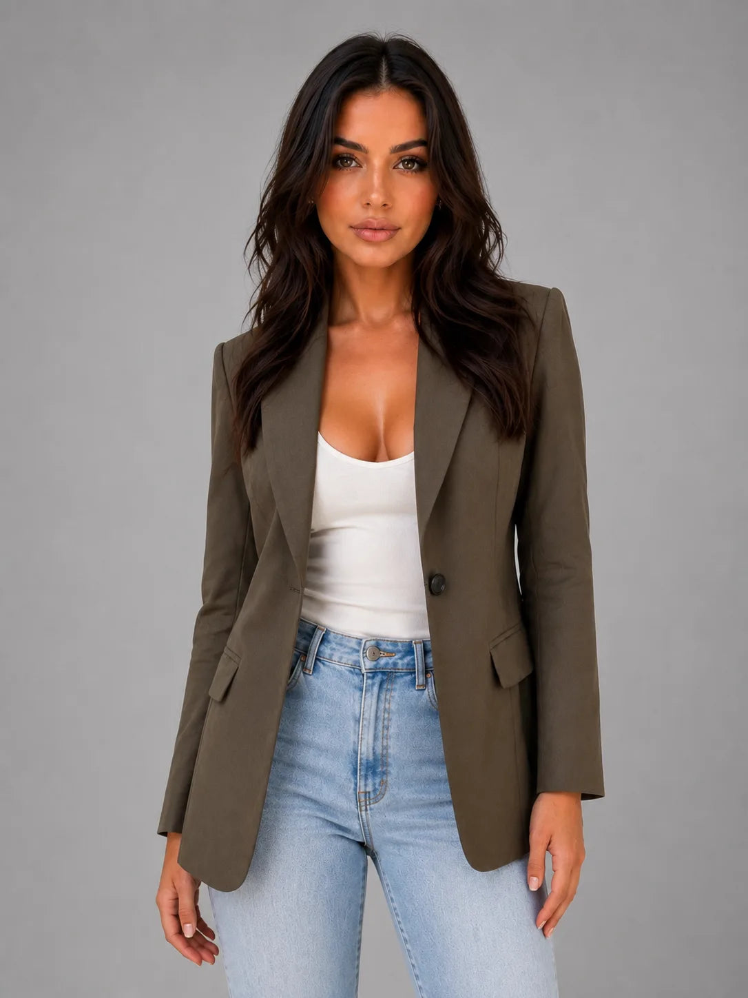 Close-up front view of the olive brown blazer styled over a white top, showing the single button and lapel detail