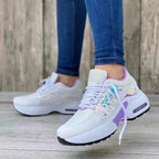 White, grey and lilac iridescent trainers with chunky white sole, close-up side profile on foot