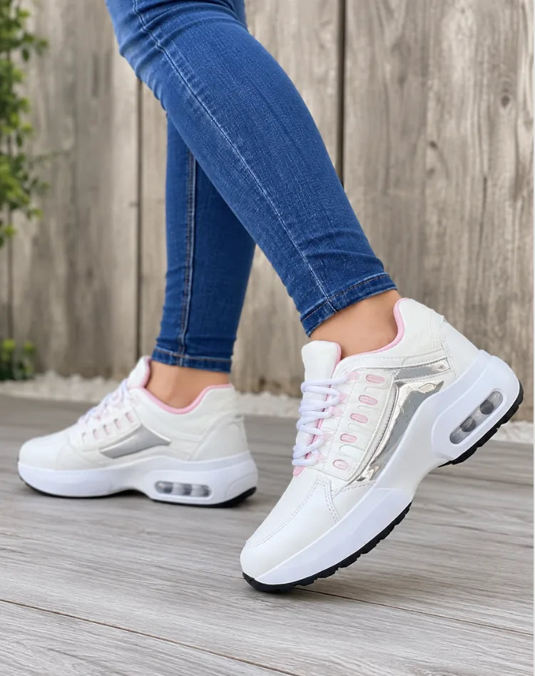 Cream white trainers with pink lining and metallic silver panel, lace-up front, shown from above on foot