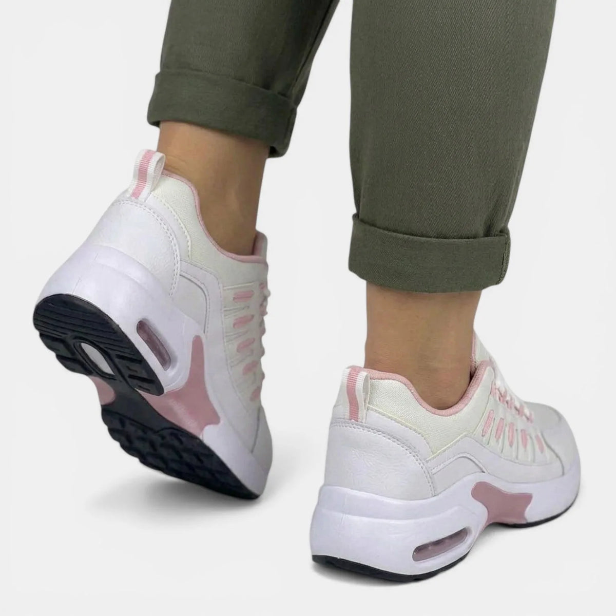 Rear view showing the air-cushion heel pod in pink and white, with black ridged outsole