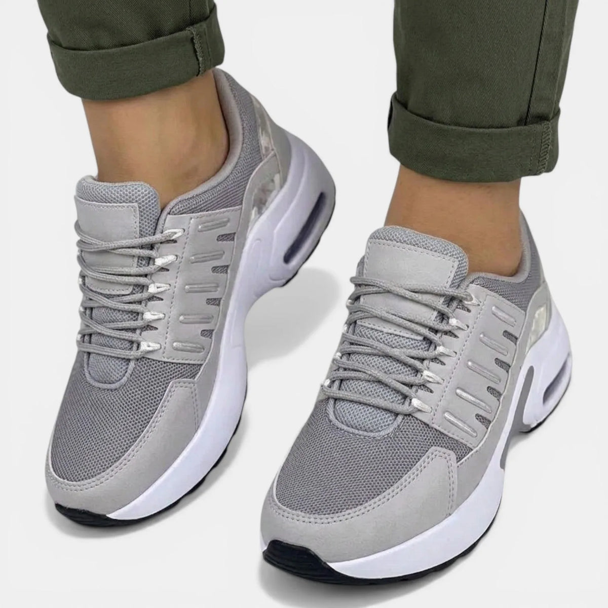 Front view of grey mesh trainers with silver-tone eyelets and lace-up front