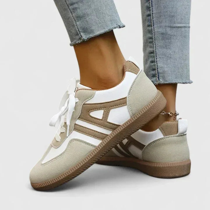Angled side view highlighting the panelled suede and leather upper with brown stripe detail and gum sole