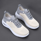 Top-down view of grey and beige mesh trainers with contrast heel panel, lace-up front and white chunky outsole