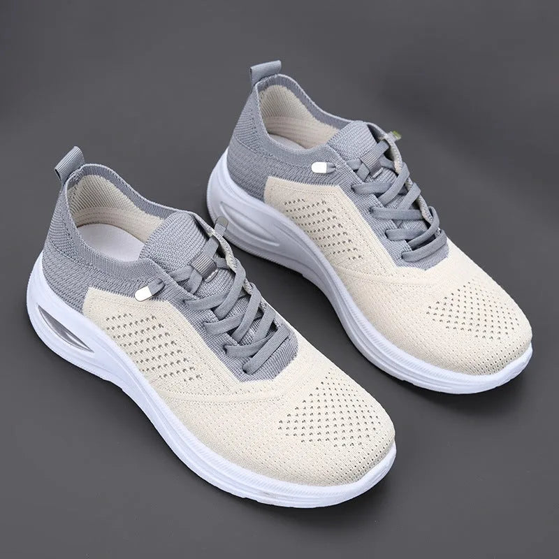 Top-down view of grey and beige mesh trainers with contrast heel panel, lace-up front and white chunky outsole