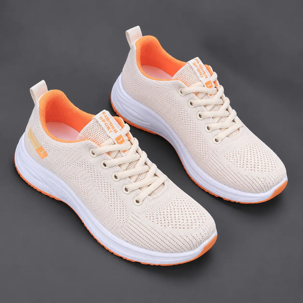 Pair of cream mesh trainers with bright orange lining and sole trim, lace-up front and ribbed pull tab