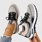 Close-up side view of black, grey and beige mesh trainers showing contrast panel detail and thick outsole
