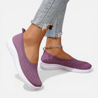 Purple knit slip-on trainer shown side by side, woven texture and white cushioned sole visible