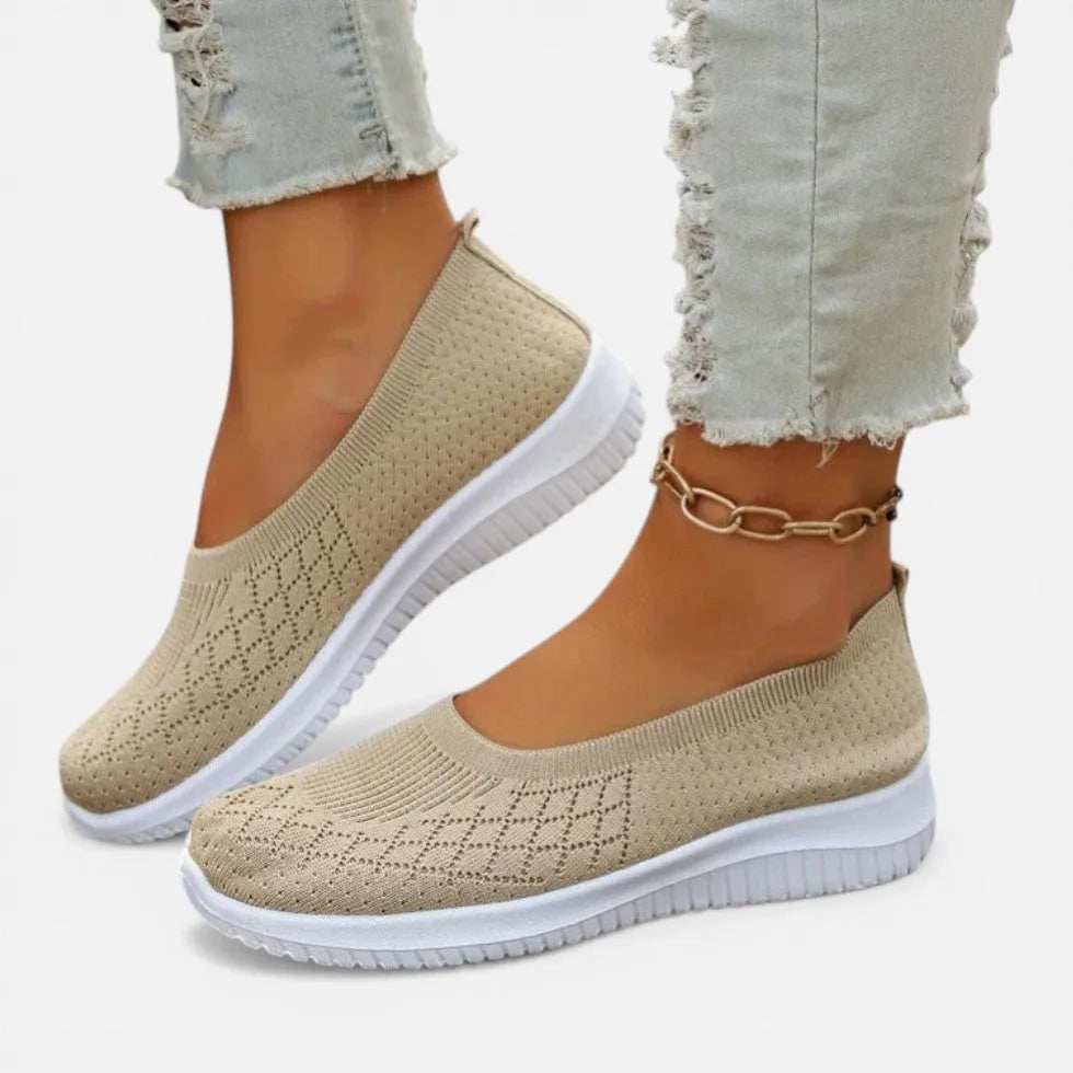 Beige knit slip-on trainer with diamond stitch pattern, worn with light denim and a chain anklet