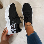 Top-down view of white trainers highlighting the lace-up front and contrast stripe side panel