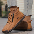 Light blue leather high-top trainer with gold anklet accessory, laces and zip pull in sharp focus