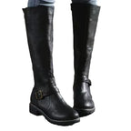Pair of black leather knee-high boots on white background showing full silhouette and buckle trim