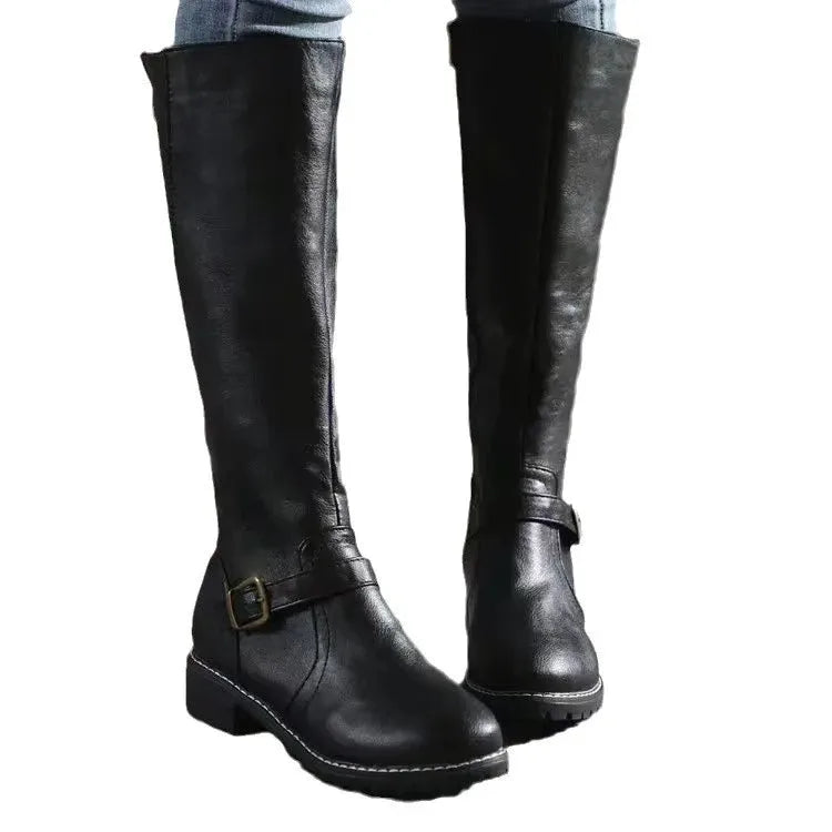 Pair of black leather knee-high boots on white background showing full silhouette and buckle trim