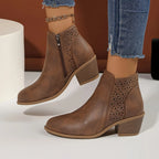 Both black ankle boots shown together from the side, showcasing matching perforated panels and heel height