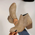 Close-up of black ankle boot side profile showing zipper, cut-out detail and rounded toe