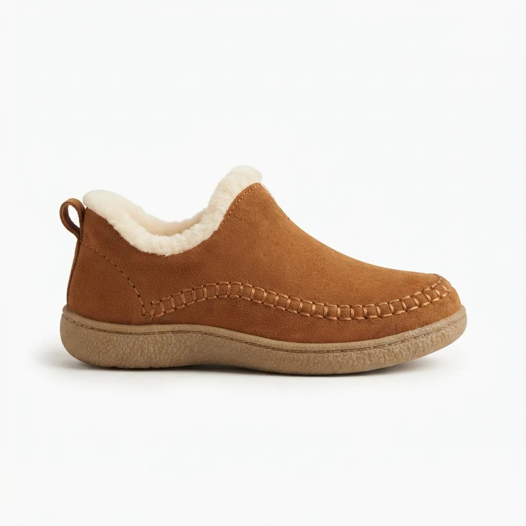 Side view of a tan suede ankle boot with cream shearling trim and a woven stitch detail along the moccasin toe
