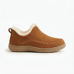 Side view of a tan suede ankle boot with cream shearling trim and a woven stitch detail along the moccasin toe