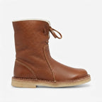 Side view of a tan brown leather slouch boot with cream shearling-look cuff and leather tie laces