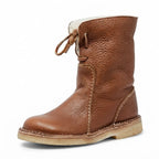 Three-quarter angle of the brown leather boot showing the crepe-style sole and stitched seam detail