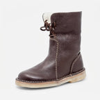 Three-quarter view of the boot in dark brown leather with contrast stitching and crepe sole