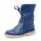 Three-quarter view of the boot in navy blue leather with tonal laces and a natural crepe sole