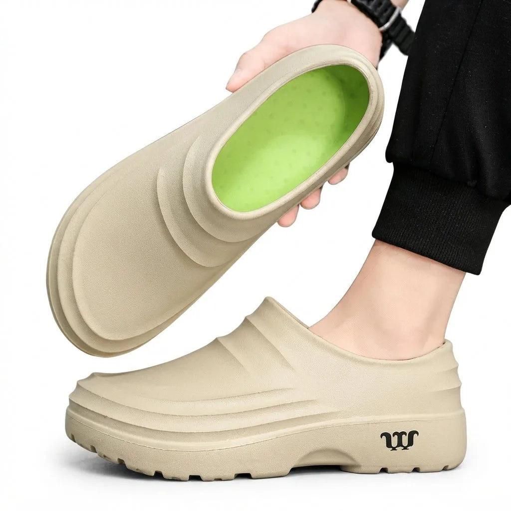 Beige clog tilted to show the bright green cushioned insole against the tan outer shell