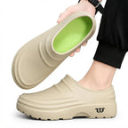 Beige clog tilted to show the bright green cushioned insole against the tan outer shell