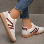 Close-up of brown and tan trainers showing suede texture, lace detail and heel branding