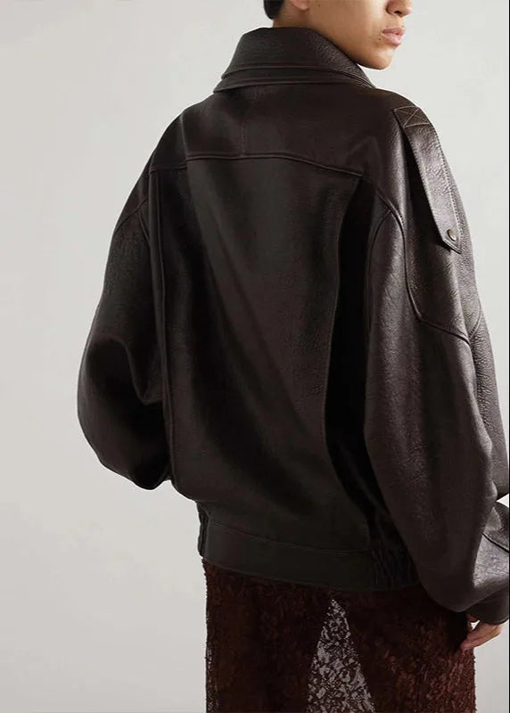 Back view of the oversized brown leather jacket highlighting the dropped shoulders and structured seams