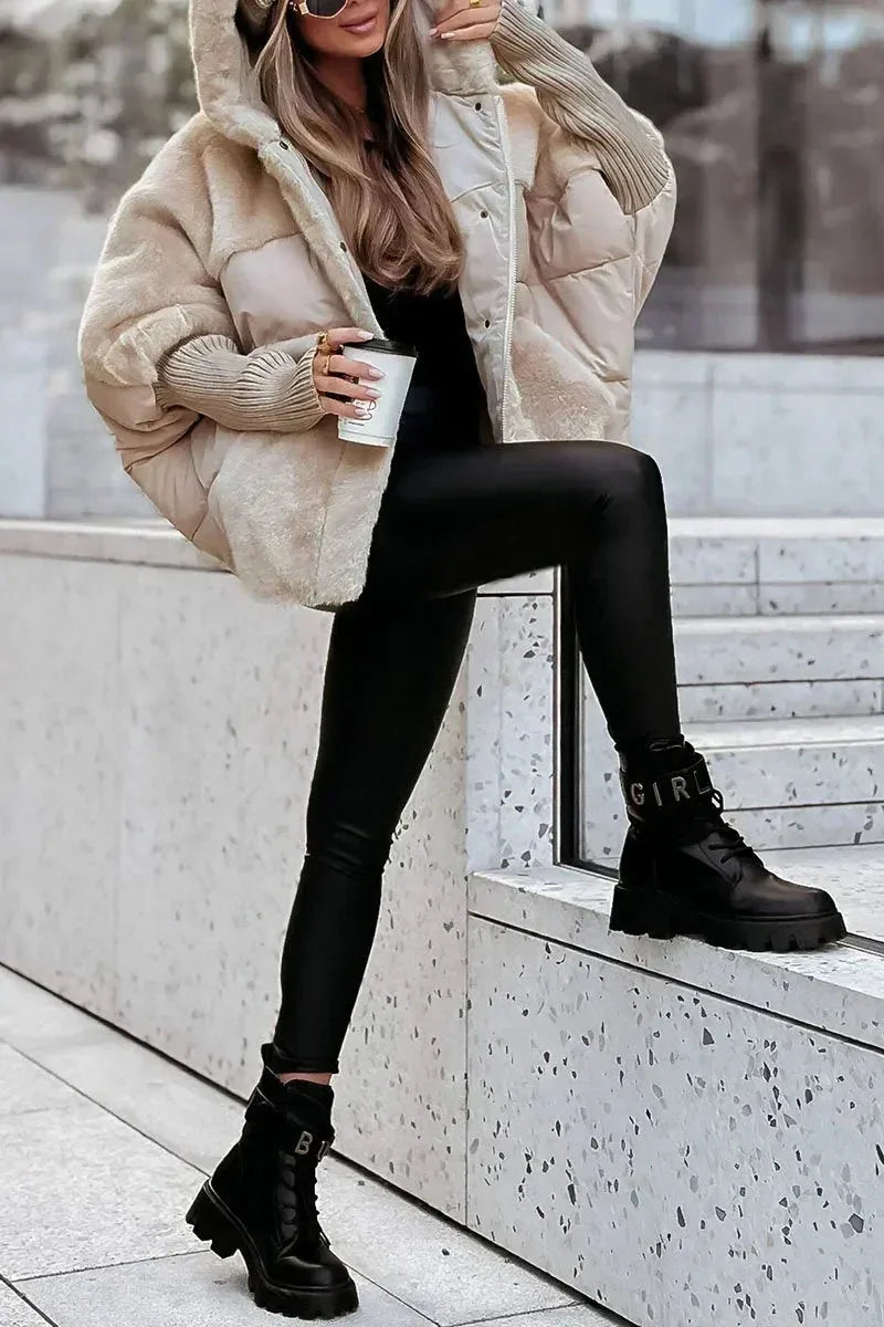 Woman wearing the camel puffer coat with hood framing the face, showing the zip fastening and snap buttons