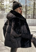Side view of the black puffer coat showing the contrast panelling between quilted nylon and faux fur