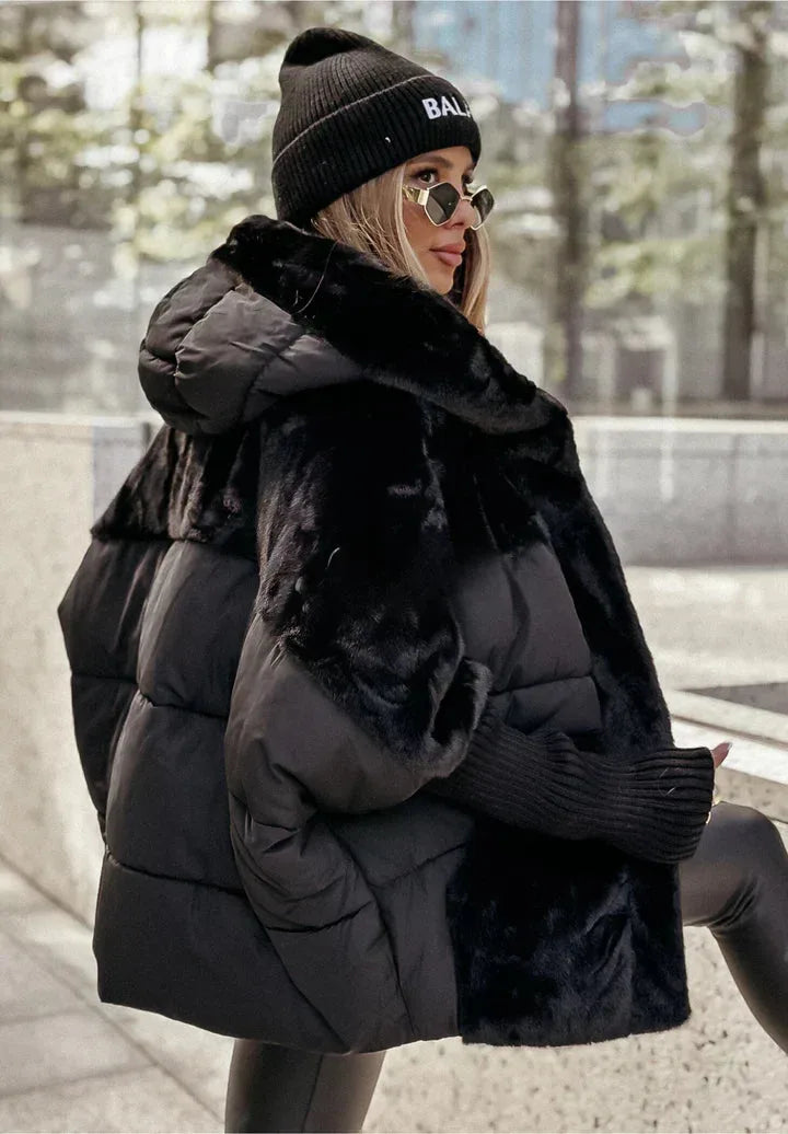 Side view of the black puffer coat showing the contrast panelling between quilted nylon and faux fur