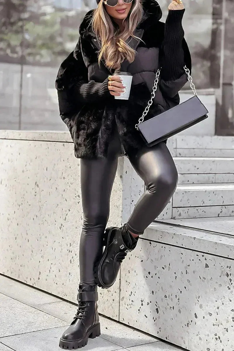 Full-length view of the black faux fur puffer coat paired with leather trousers and chunky lace-up boots