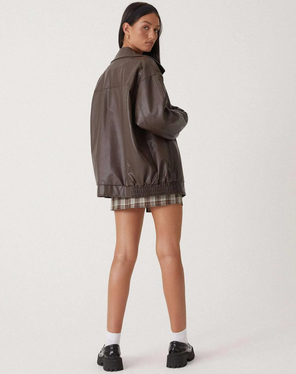 Back view of the brown oversized jacket showing the wide collar and ribbed elastic waistband