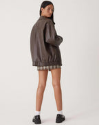 Back view of the brown oversized jacket showing the wide collar and ribbed elastic waistband
